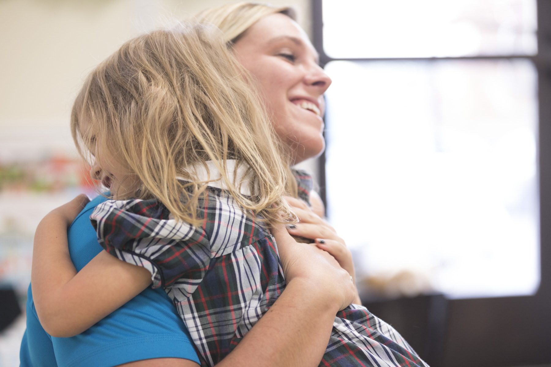 Preschooler hugging teacher