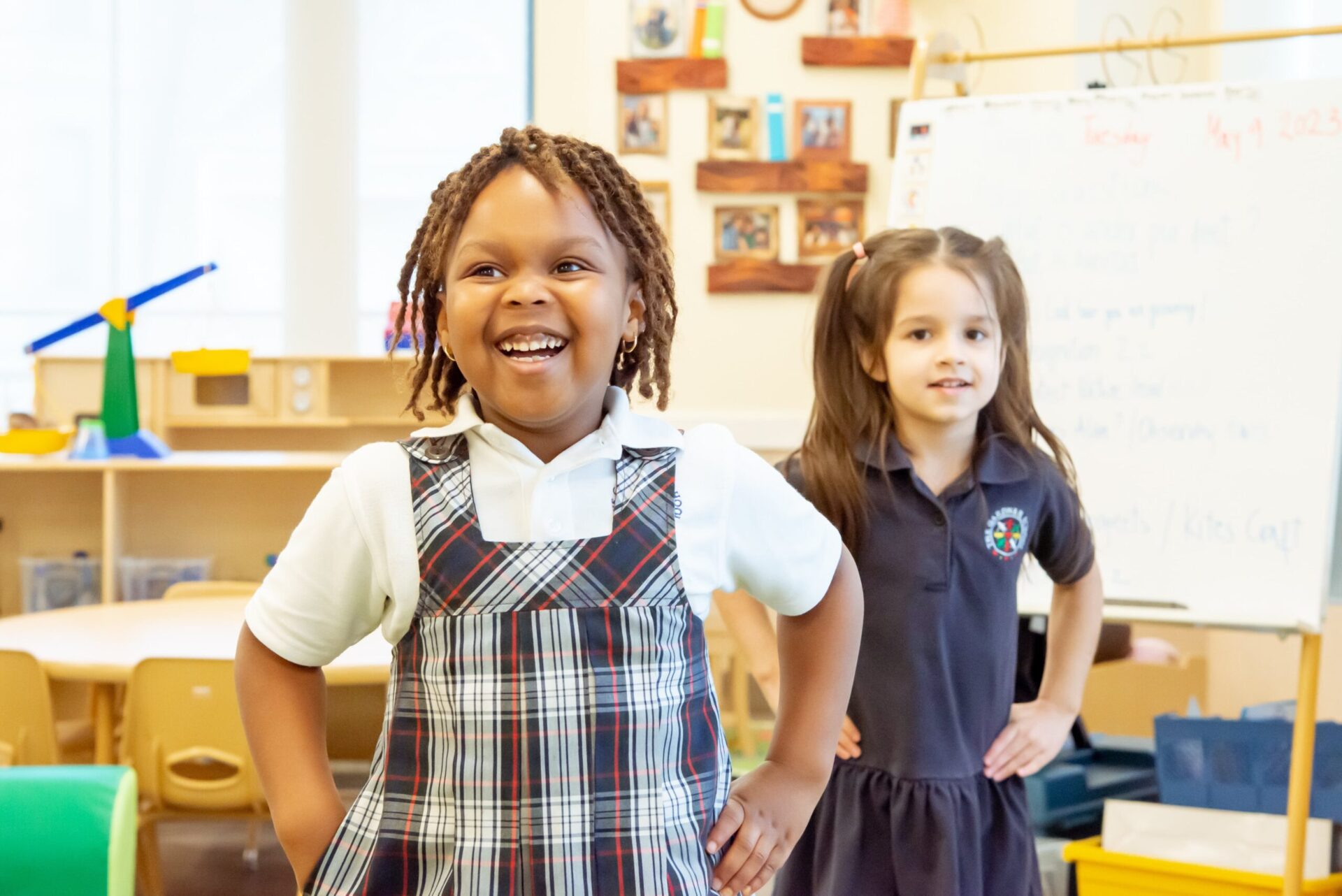 two preschool children wearing school uniforms