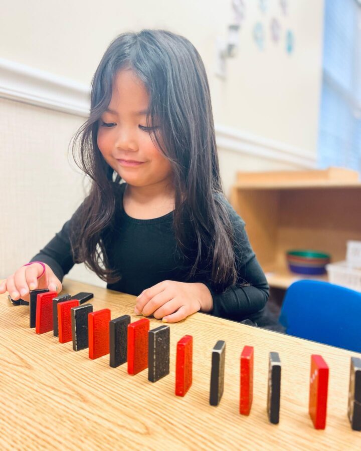 girl playing with dominoes