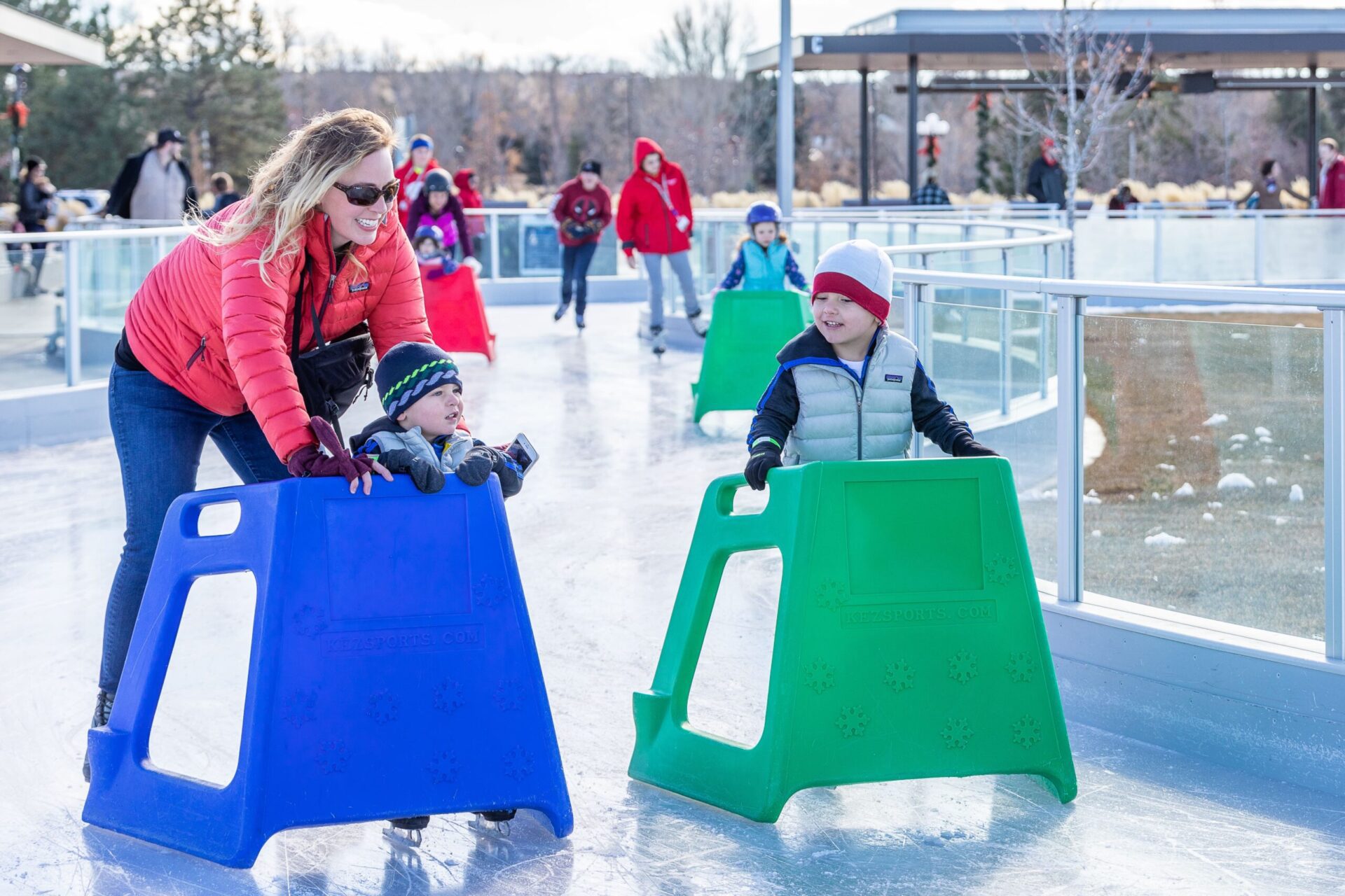 family ice skating with training aids at Parker Ice Trail