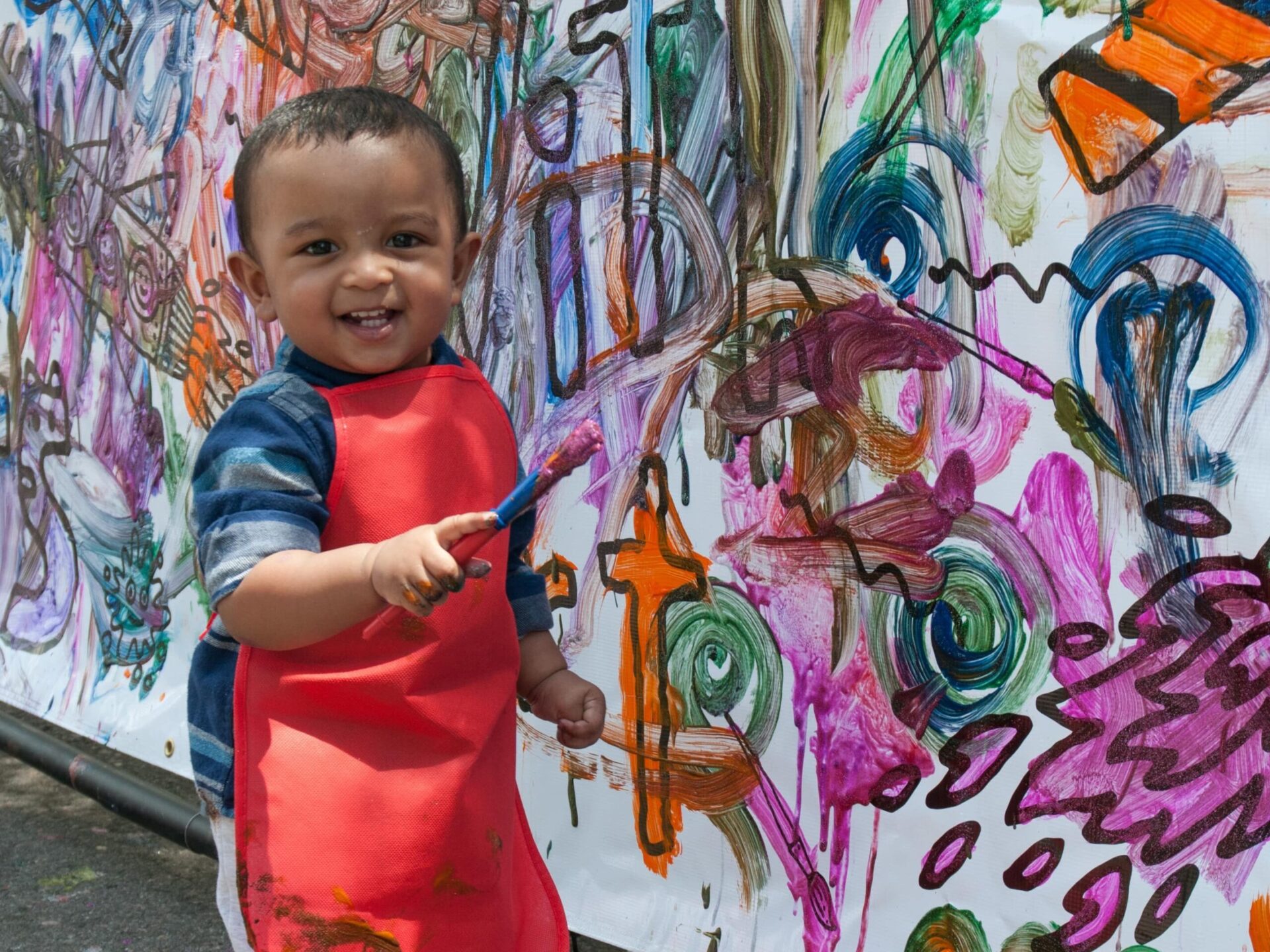 toddler painting a wall