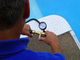 man testing pool for a leak | leak detection