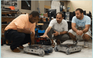 students working on machinery in a lab