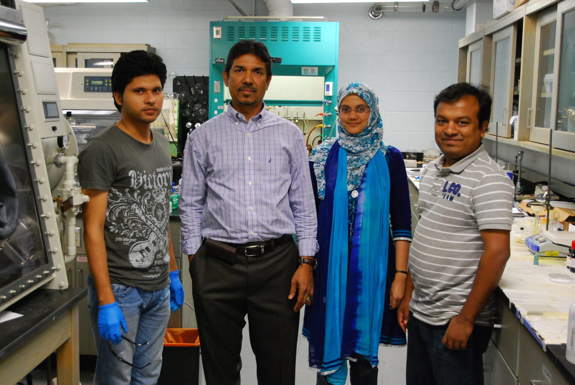A small group standing in a lab.
