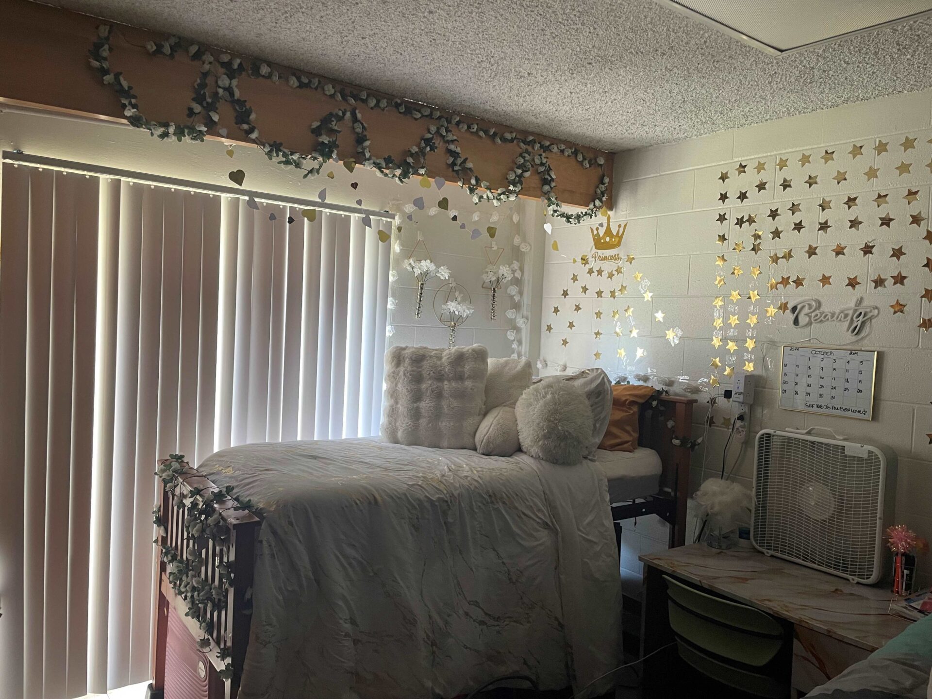 Eppse Hall dorm room with a bed with gray sheets and decor on the walls