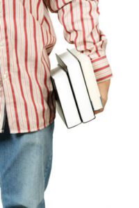 student wearing a red striped shirt holding books