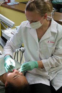 A dental student practicing dentistry.