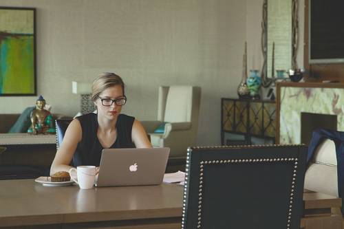 a lady sitting at a desk on a laptop