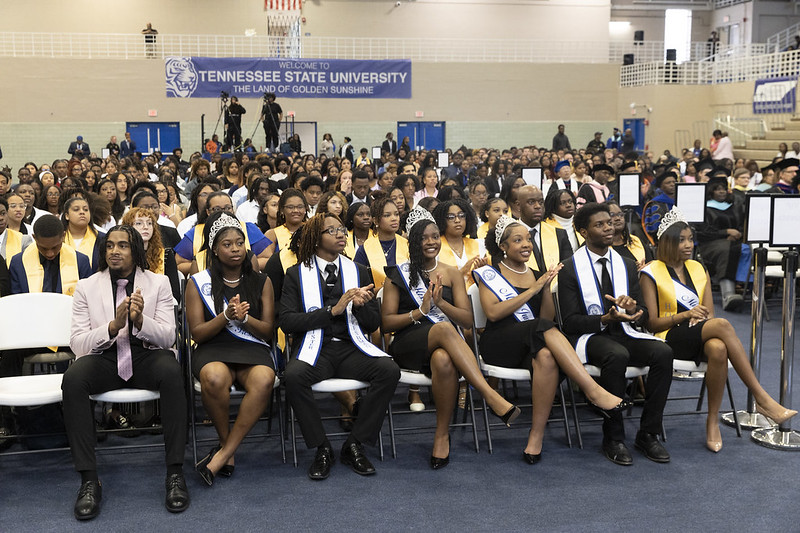 2025 honors convocation event with a bunch of students sitting down wearing crowns and stashes 