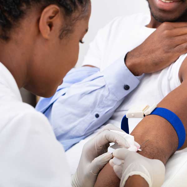 a nurse drawing blood from a patient