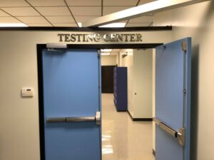 two blue doors with one door open with the words Testing Door above the doors